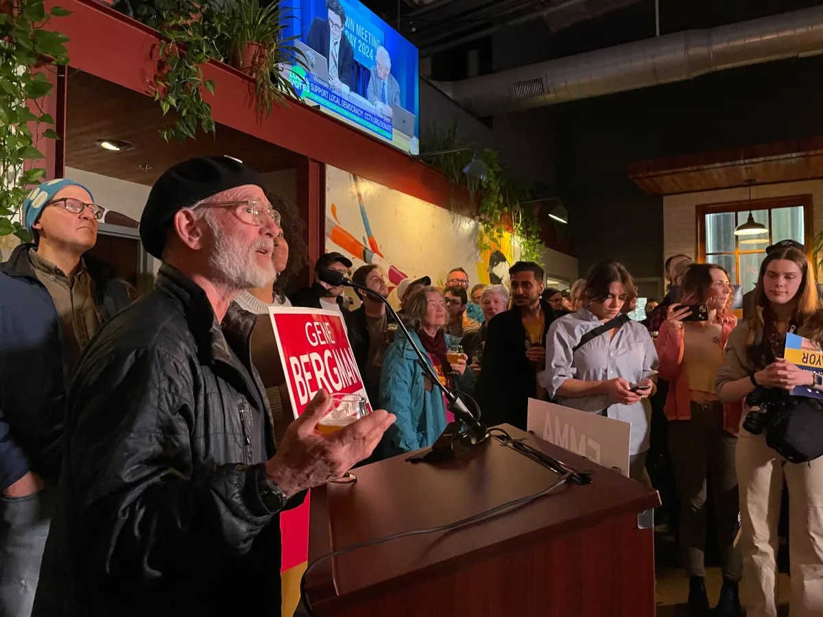 A man speaks at a podium.