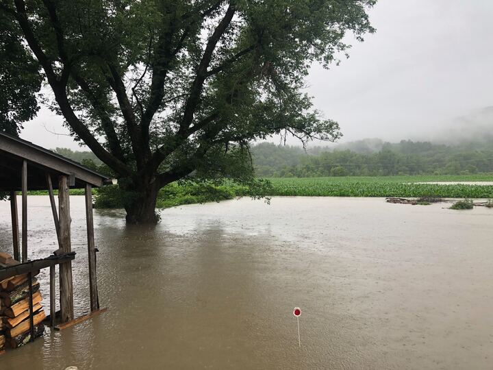a house is flooded in the middle of a field.
