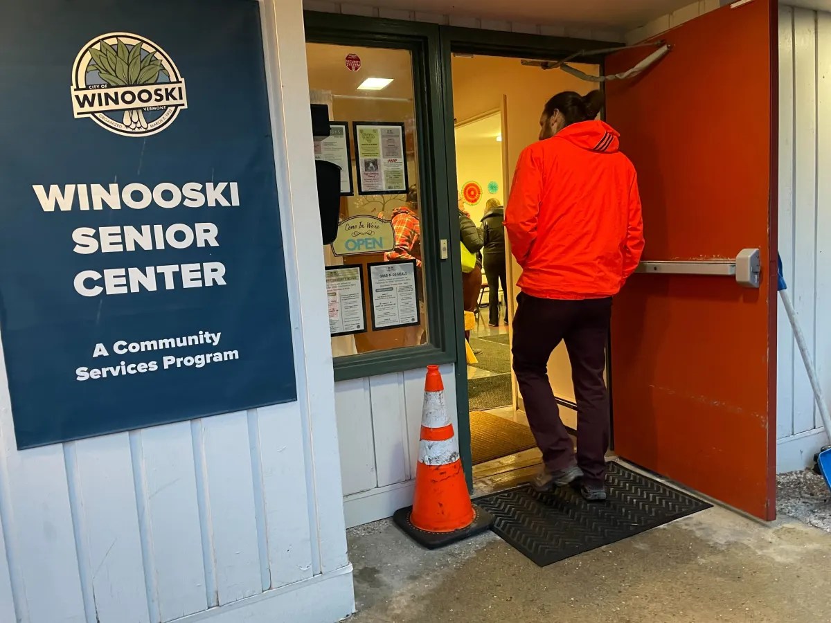 A man is standing in front of the senior center.