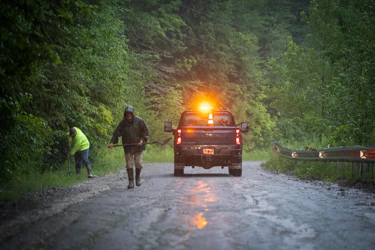 a truck is driving down a muddy road.