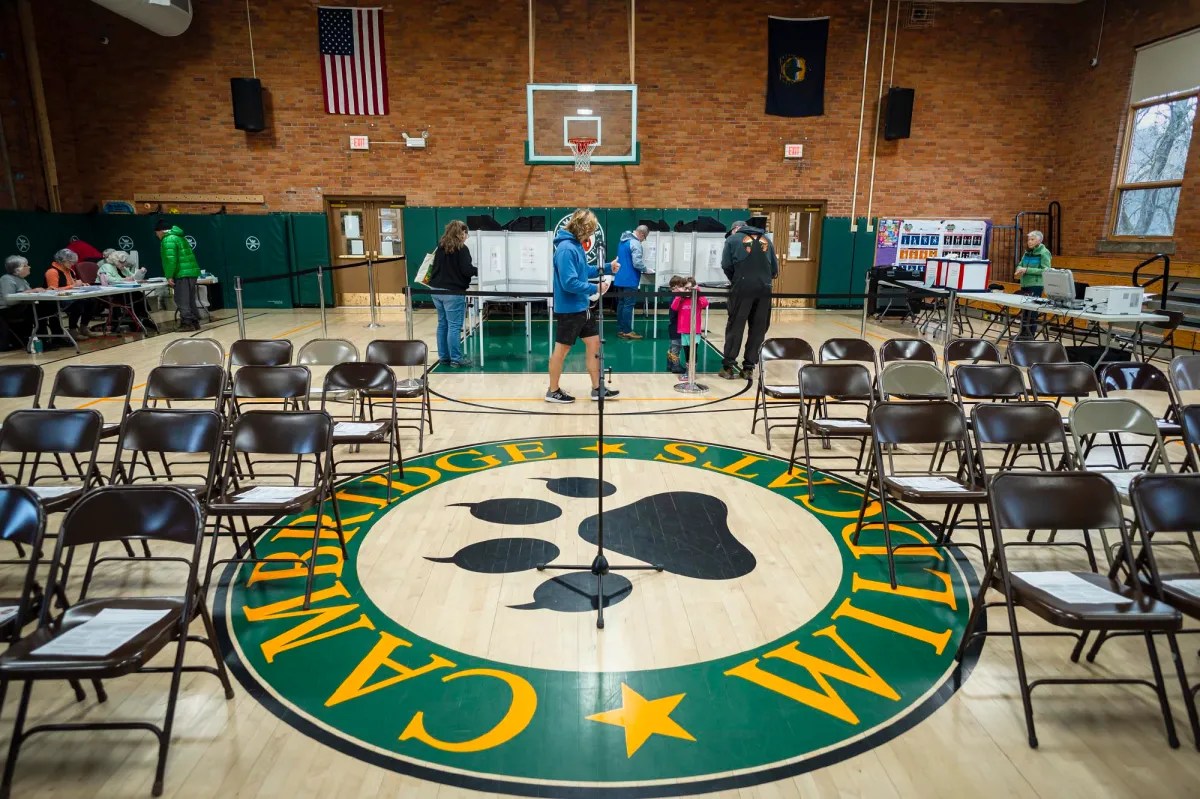 A gym with chairs and a paw print on the floor.