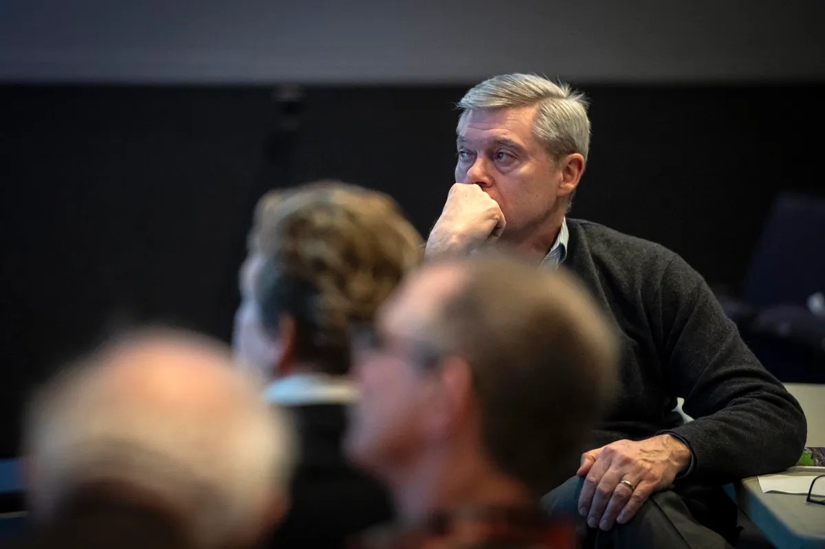 A man sitting in front of a group of people.