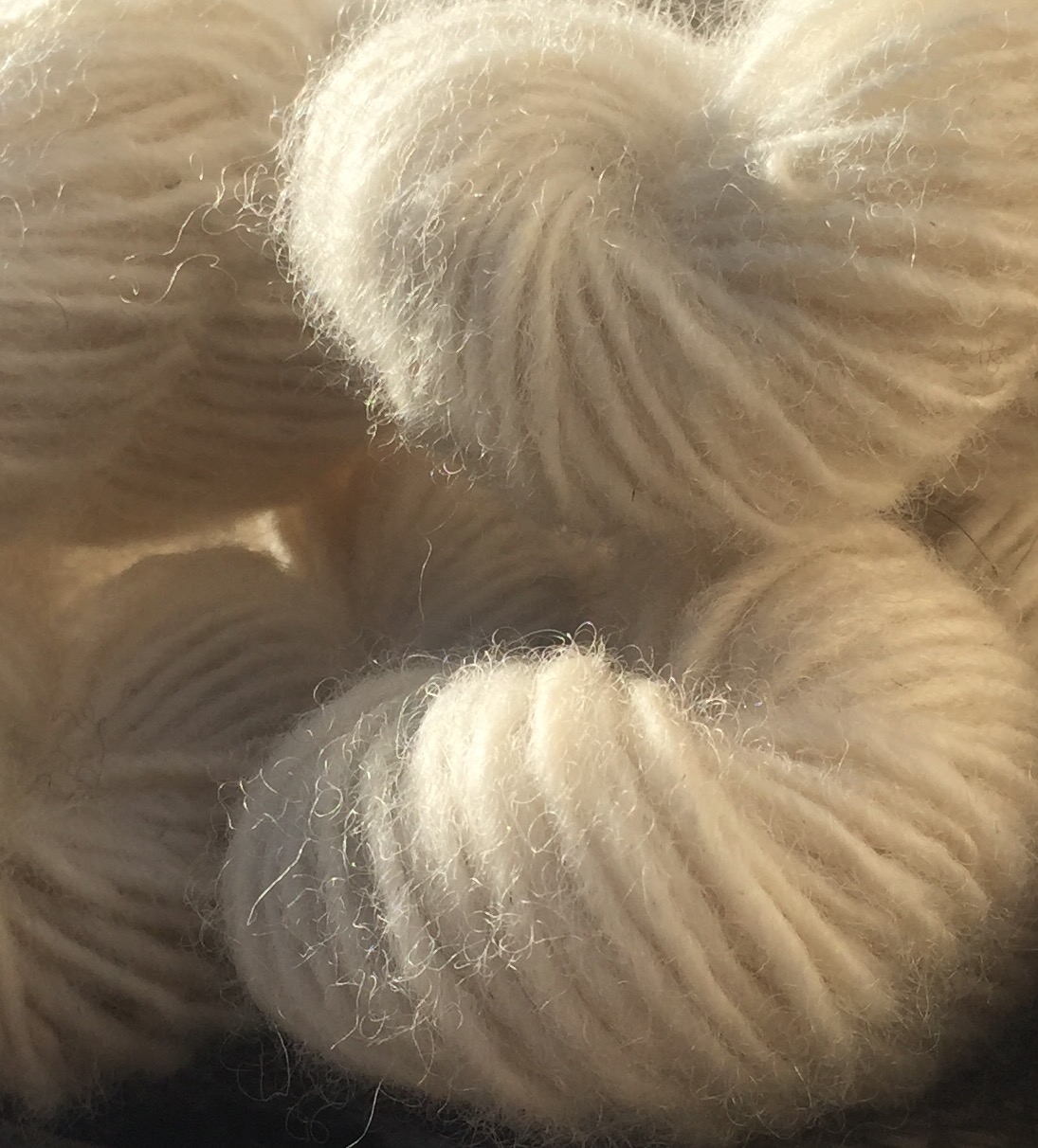 Close-up of natural white skeins of bulky singles.