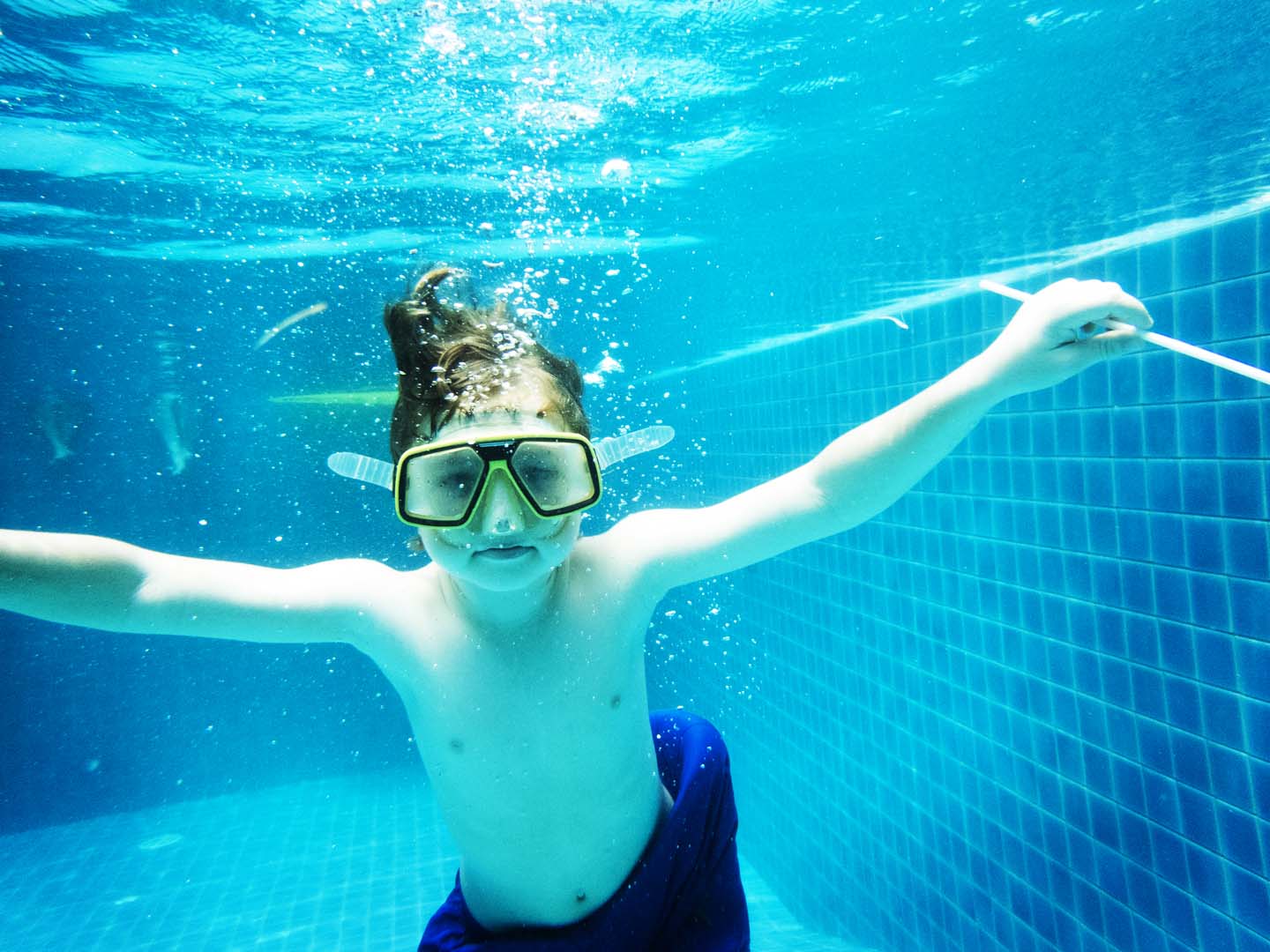 Closeup of caucasian boy underwater in the pool