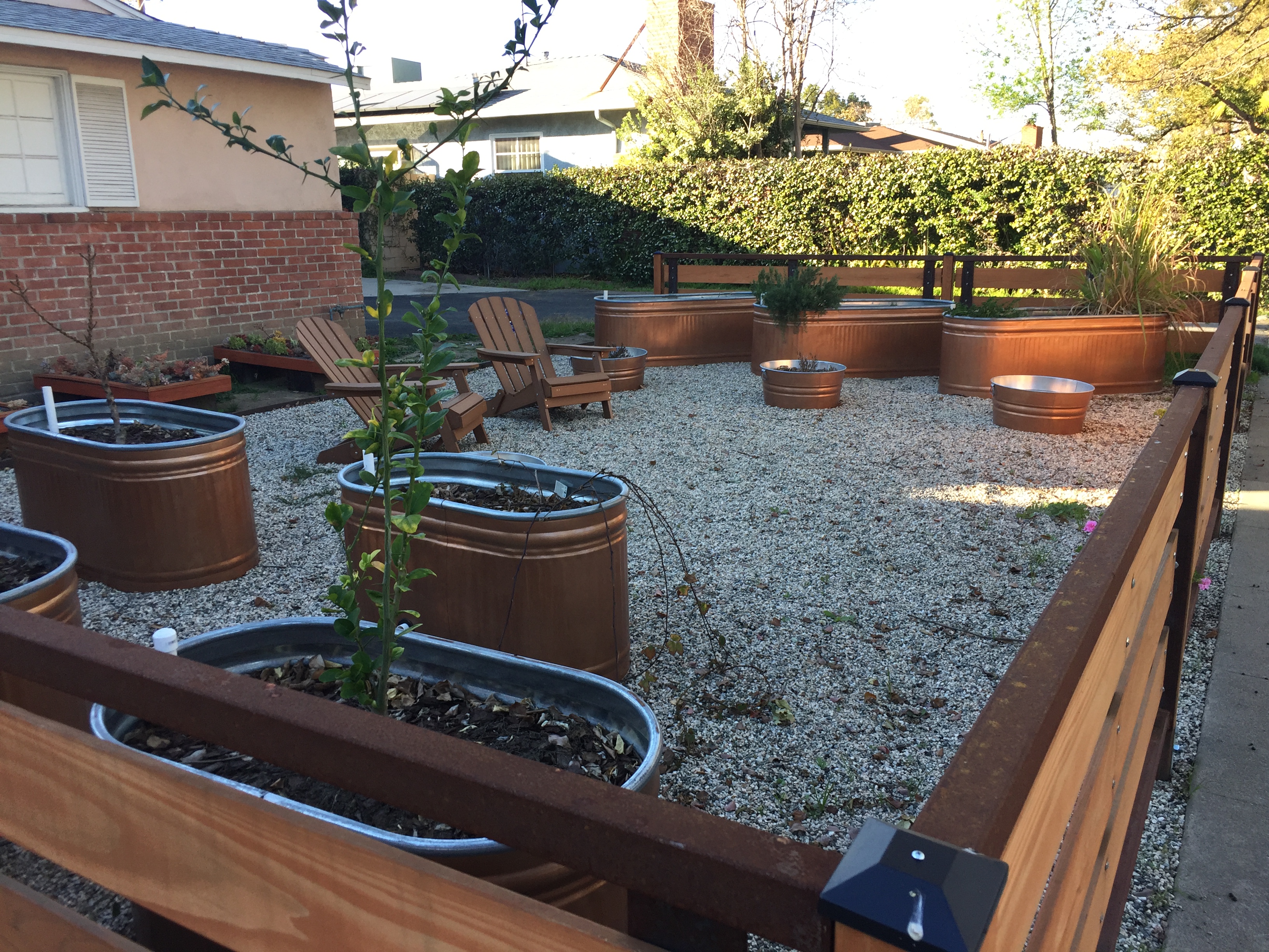 Large Scale Container Garden with Galvanized Tanks in the Neighborhood