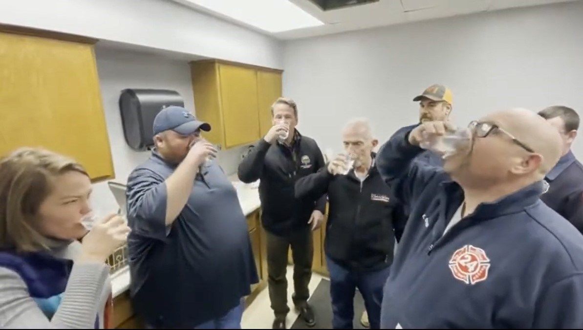 Officials drink water in East Palestine during Husted visit