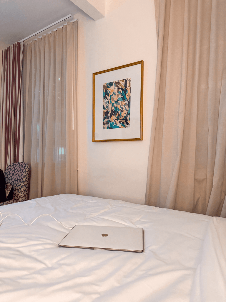 Hotel Granada Review by What Savvy Said Blogger Savannah Cyree - in photo: laptop on a bed