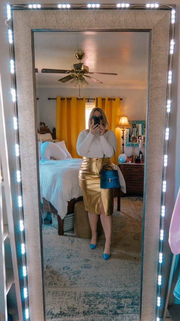 What Savvy Said shares How To Build A Wardrobe - in photo: woman taking a selfie and wearing white top and gold skirt
