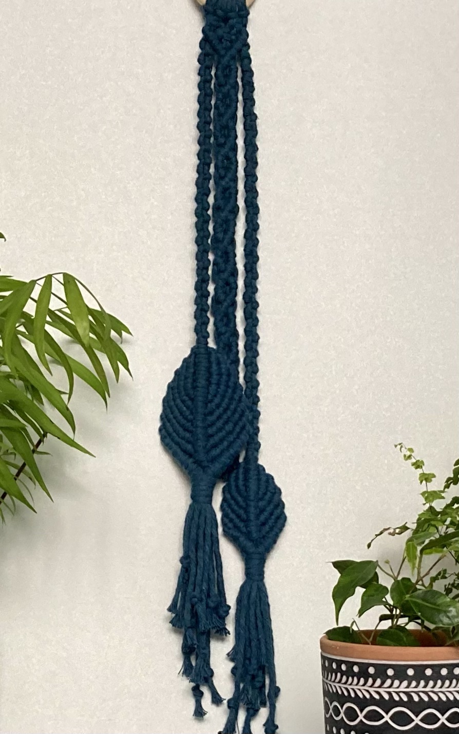 Handmade macrame wall hanging decoration in teal blue