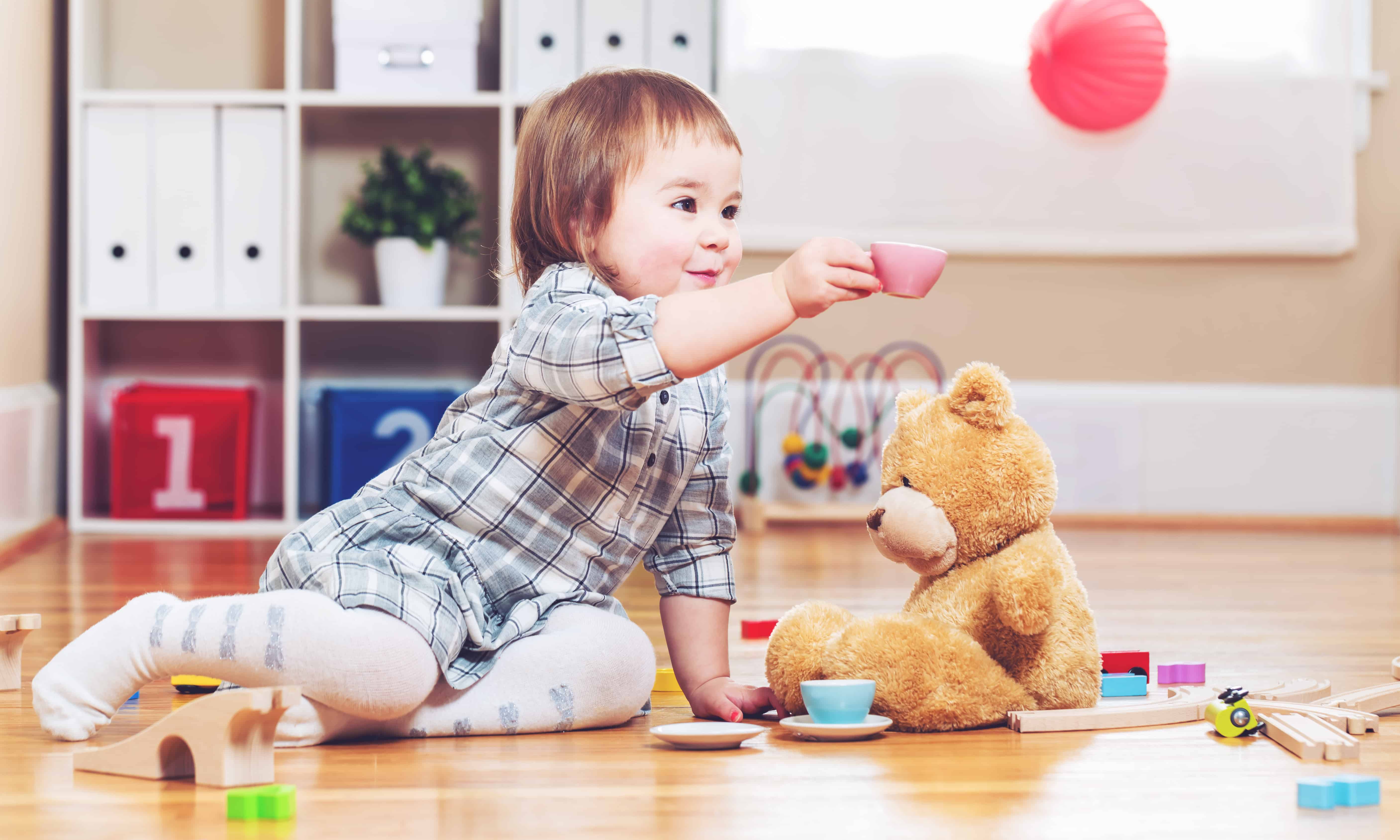 Happy toddler girl playing with her teddy bear Window Covering Safety