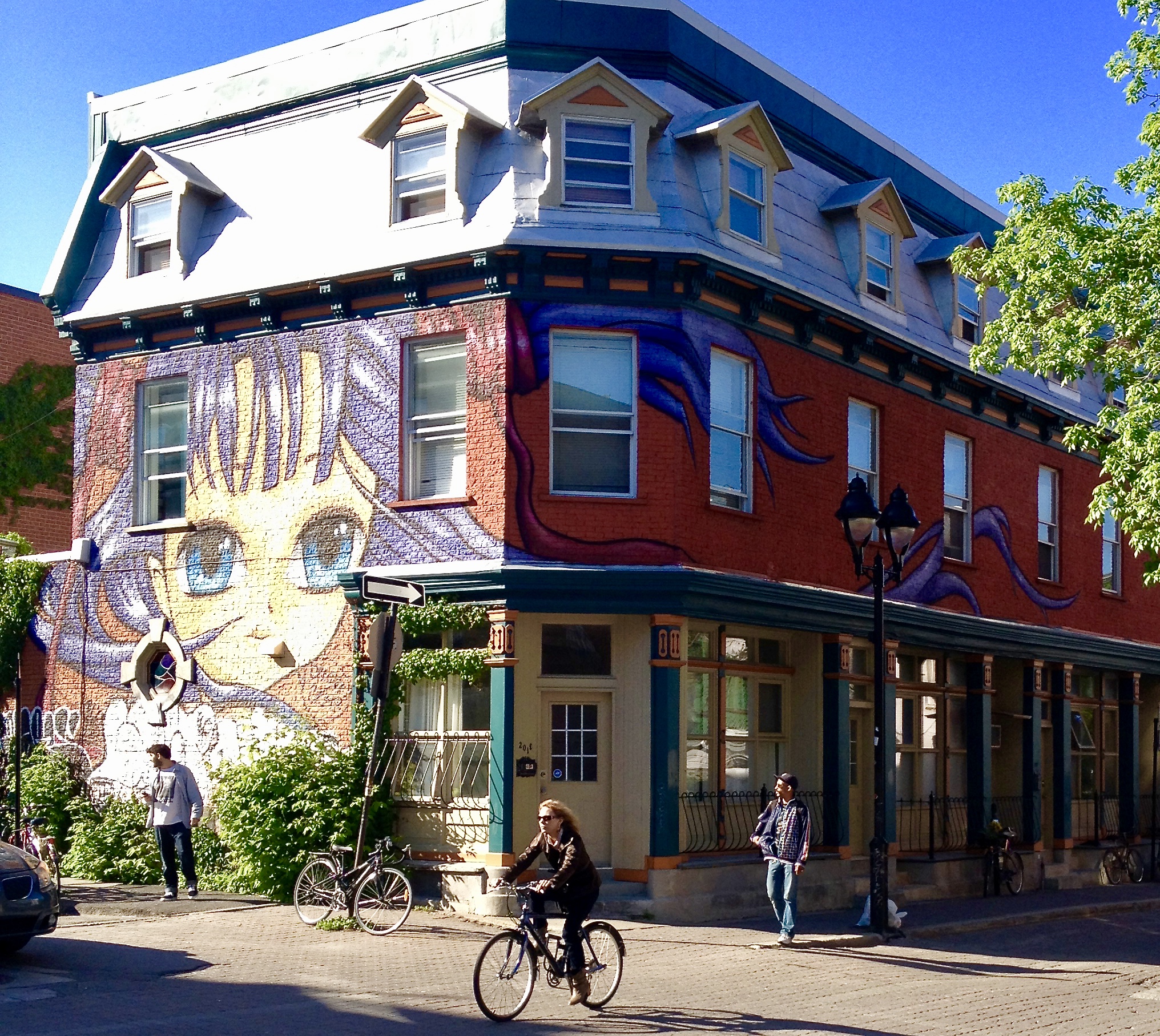 Anime style girl, whose hare wraps around the frontage of the second story of the building. 