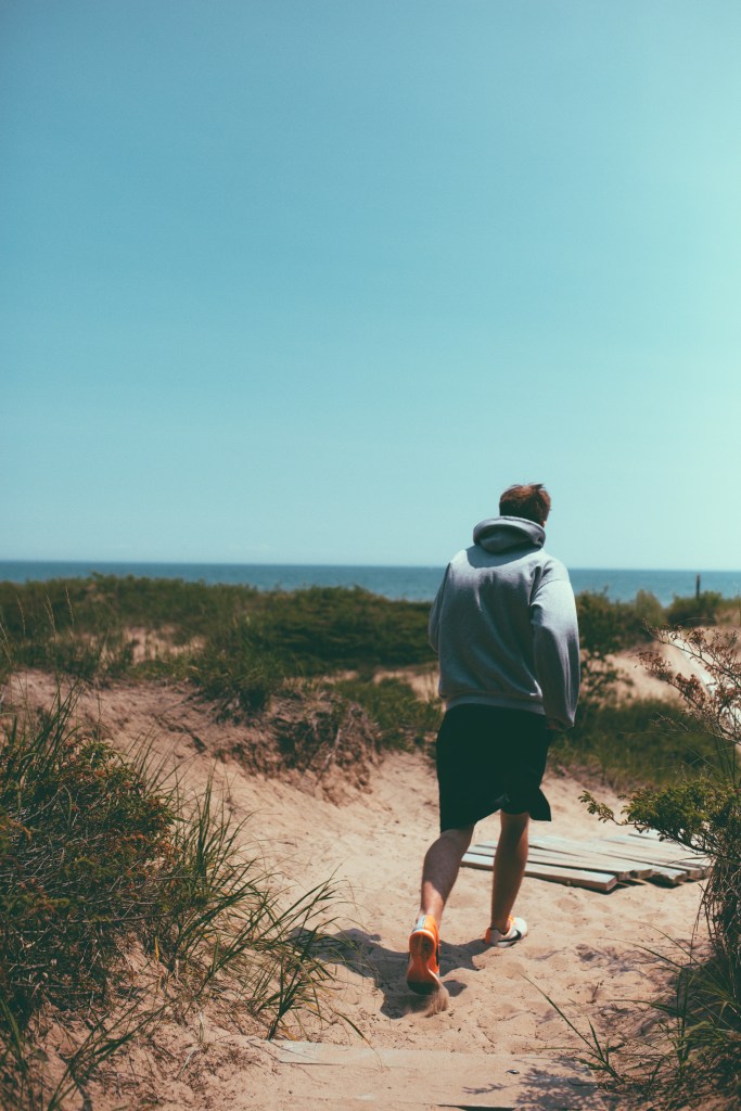 Guy running on sand dunes