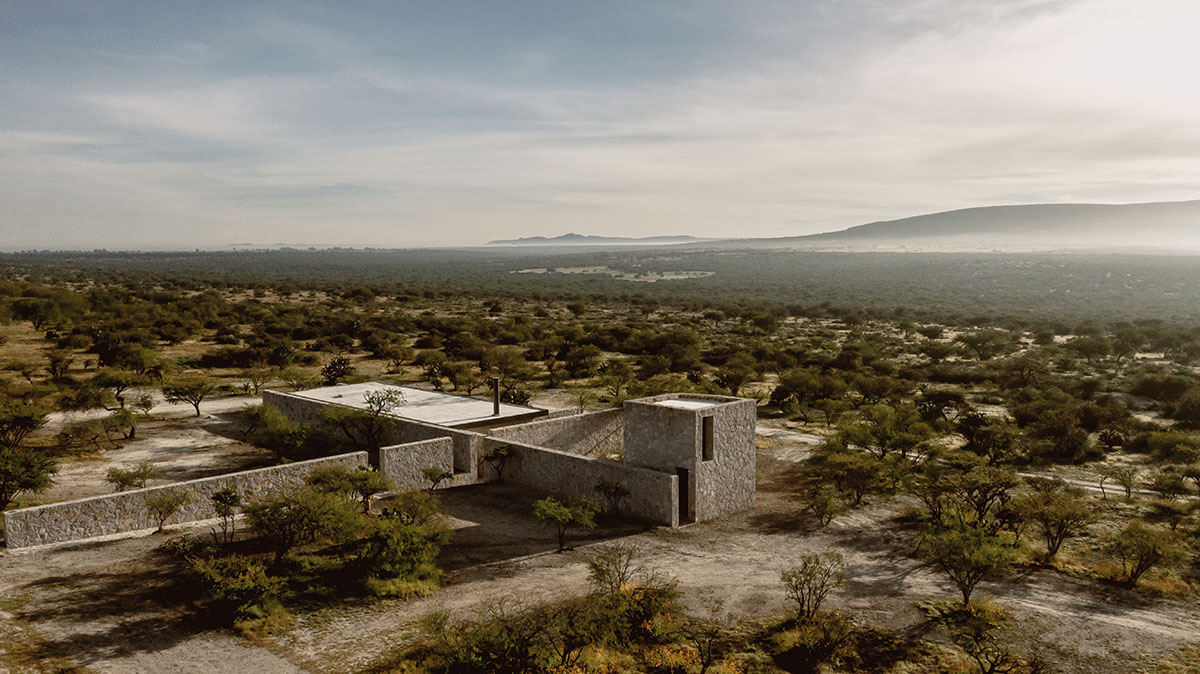 Mexican rural house by HW Studio is defined by a cross of stone walls