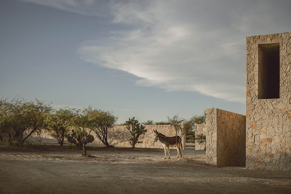Mexican rural house by HW Studio is defined by a cross of stone walls