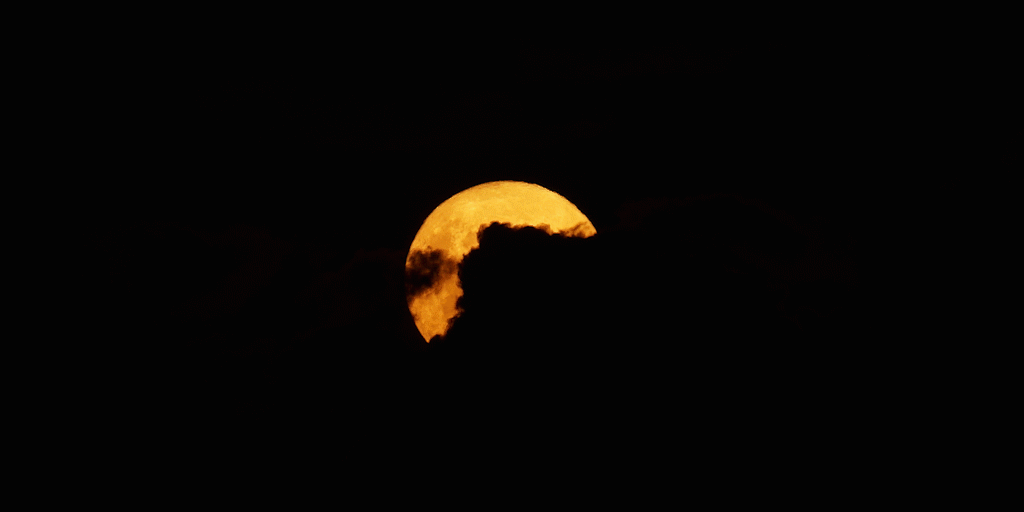 Orange moon amongst clouds corbpie