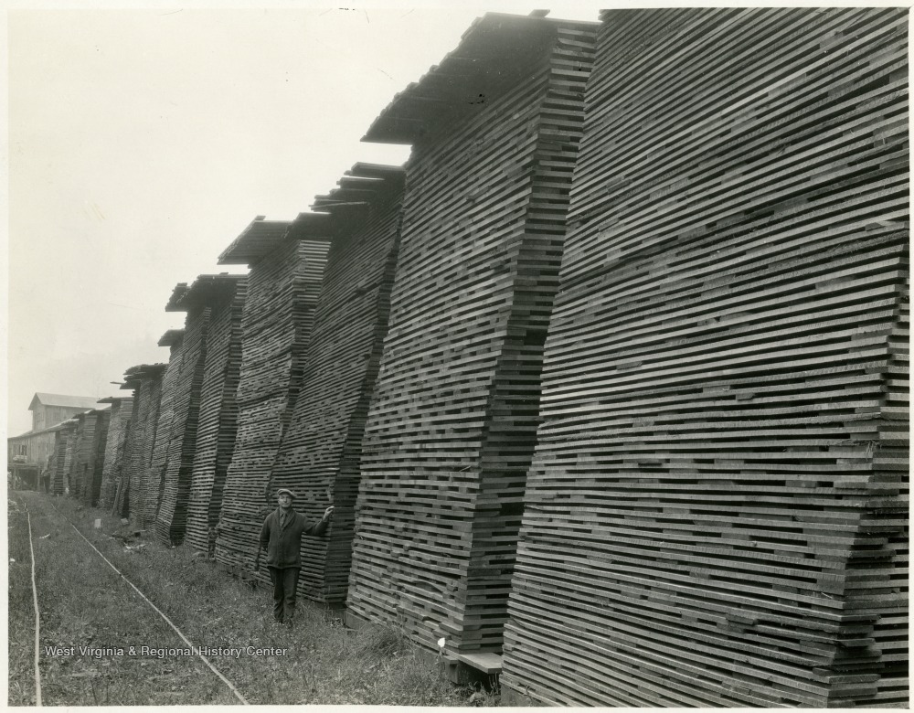 Lumber Yard Employee with Stacked Wood Panels West Virginia History OnView WVU Libraries