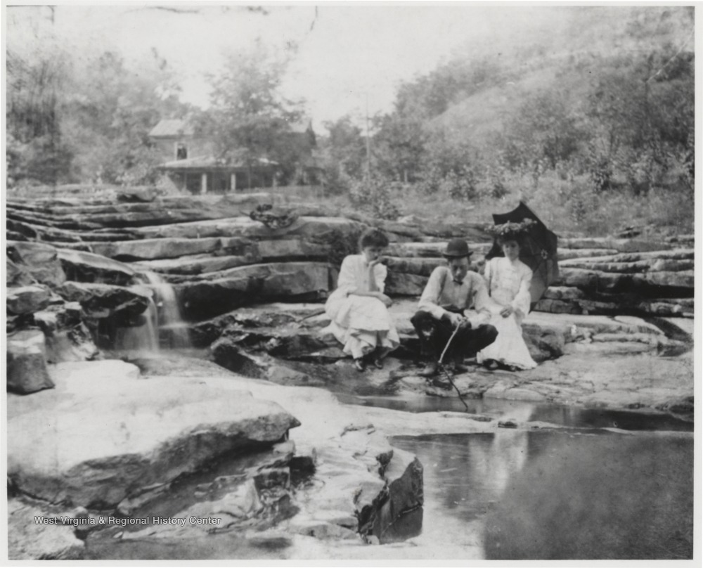 Mr. & Mrs. Robert Murrell with Associate Relax Beside a Pond near