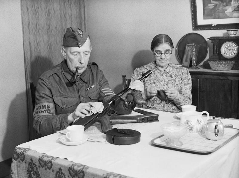 [Photo] A sergeant in the Dorking Home Guard cleaning his Thompson