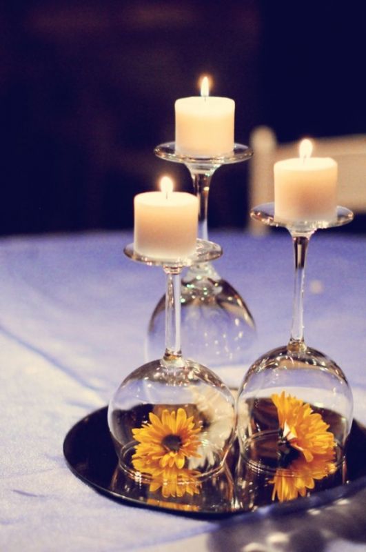 wine glass used as candle holder. put a flower or decoration under