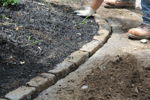 When building a garden path, use edging to keep it in place. How To Install Cobblestone Edging - A Concord Carpenter