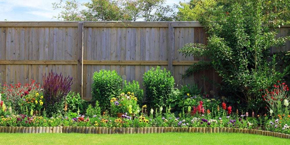 Colourful,Pretty,Flower,And,Shrub,Border,Surrounded,By,A,Fence The