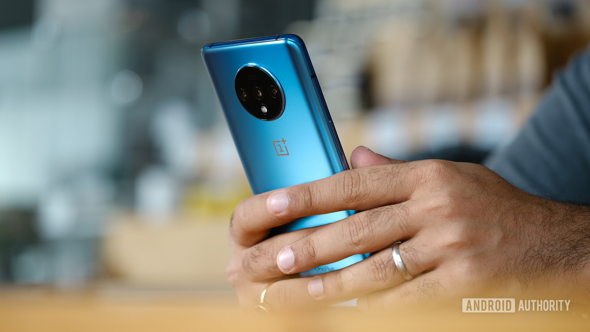 OnePlus 7T using in hand on table