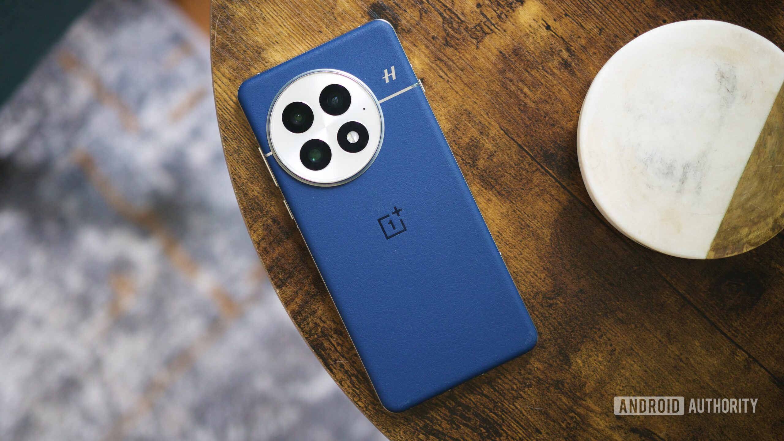 oneplus 13 blue back angle A OnePlus 13 laying face-down on a table.