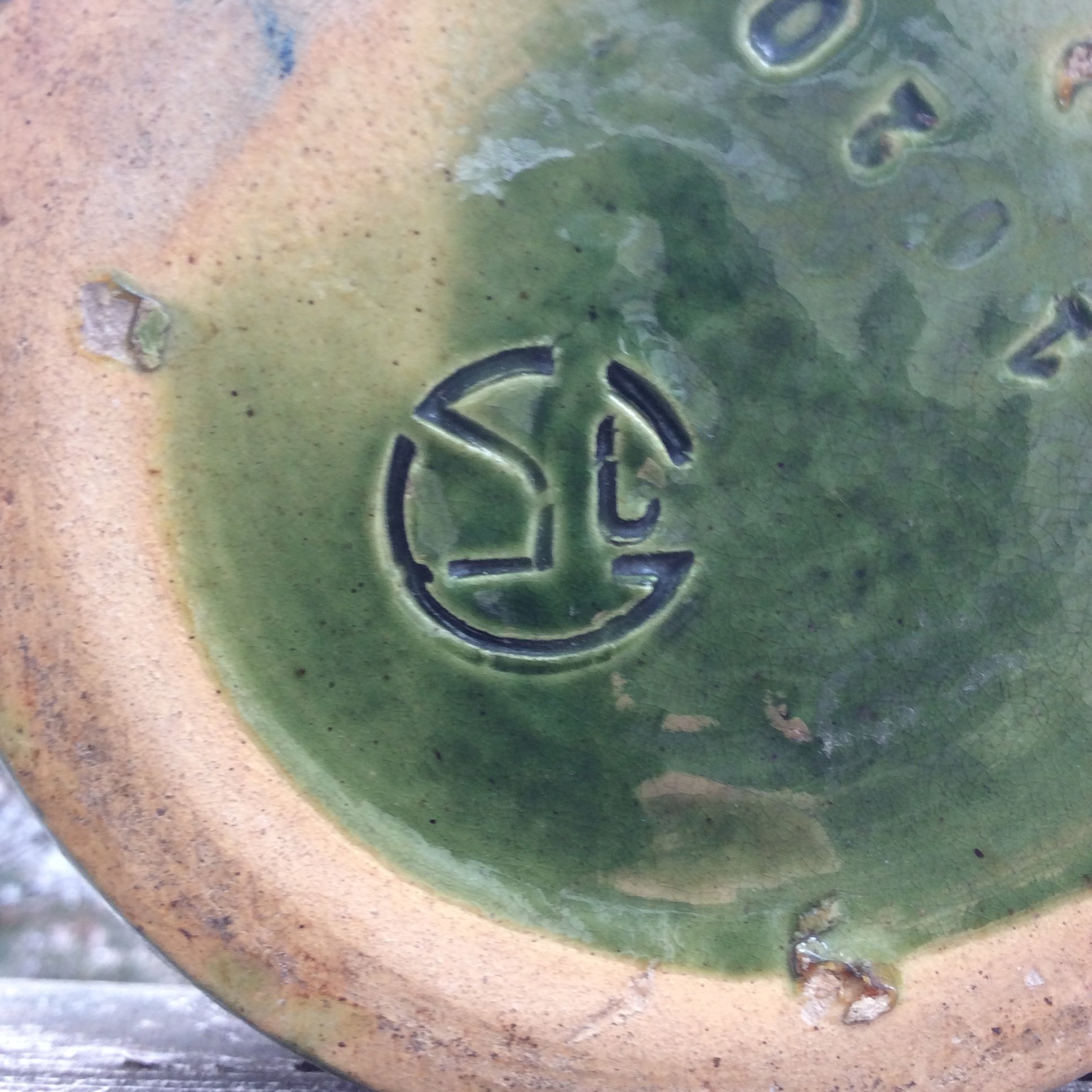 Green glaze pottery with signature Antiques Board