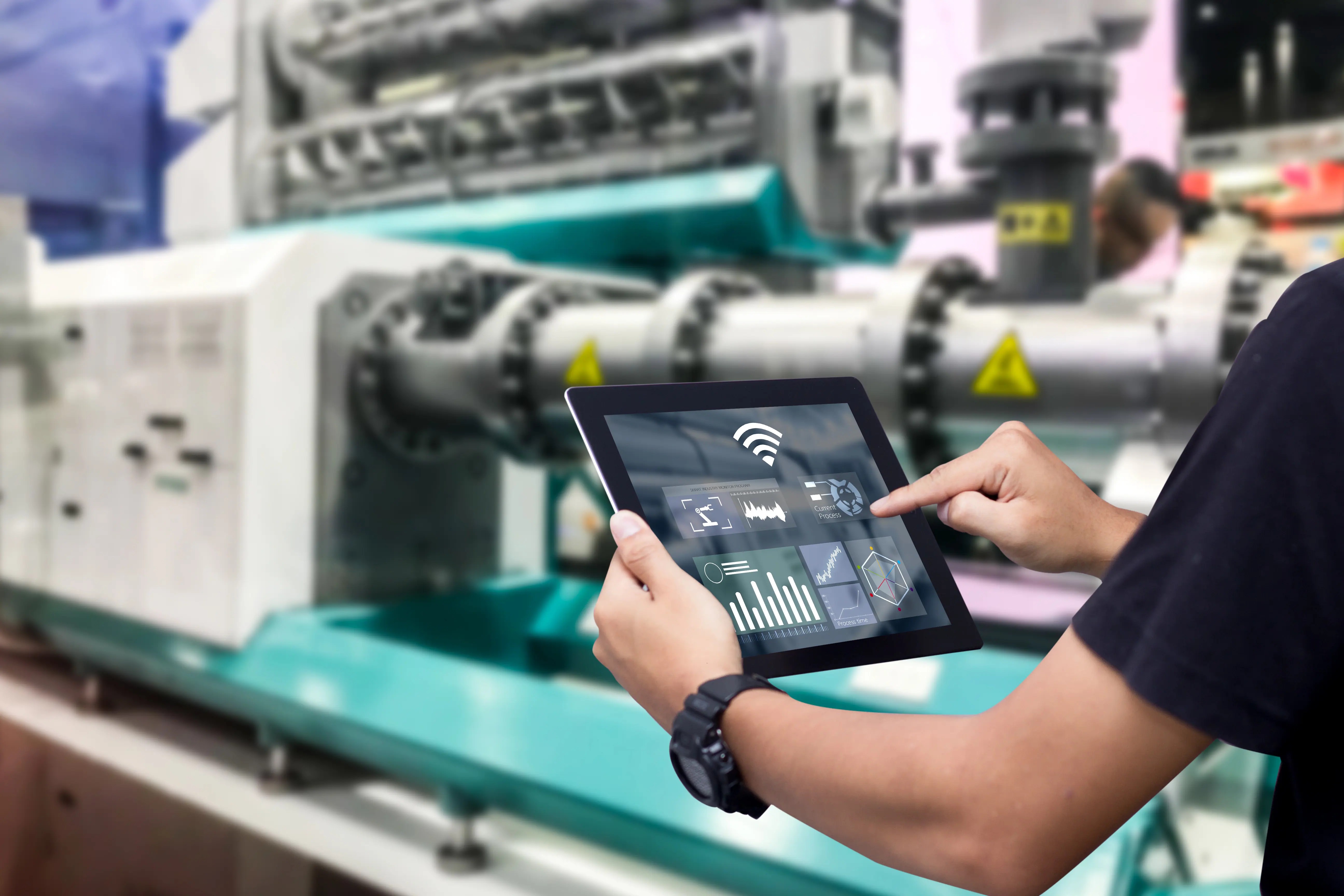 Smart industry control concept.Hands holding tablet on blurred