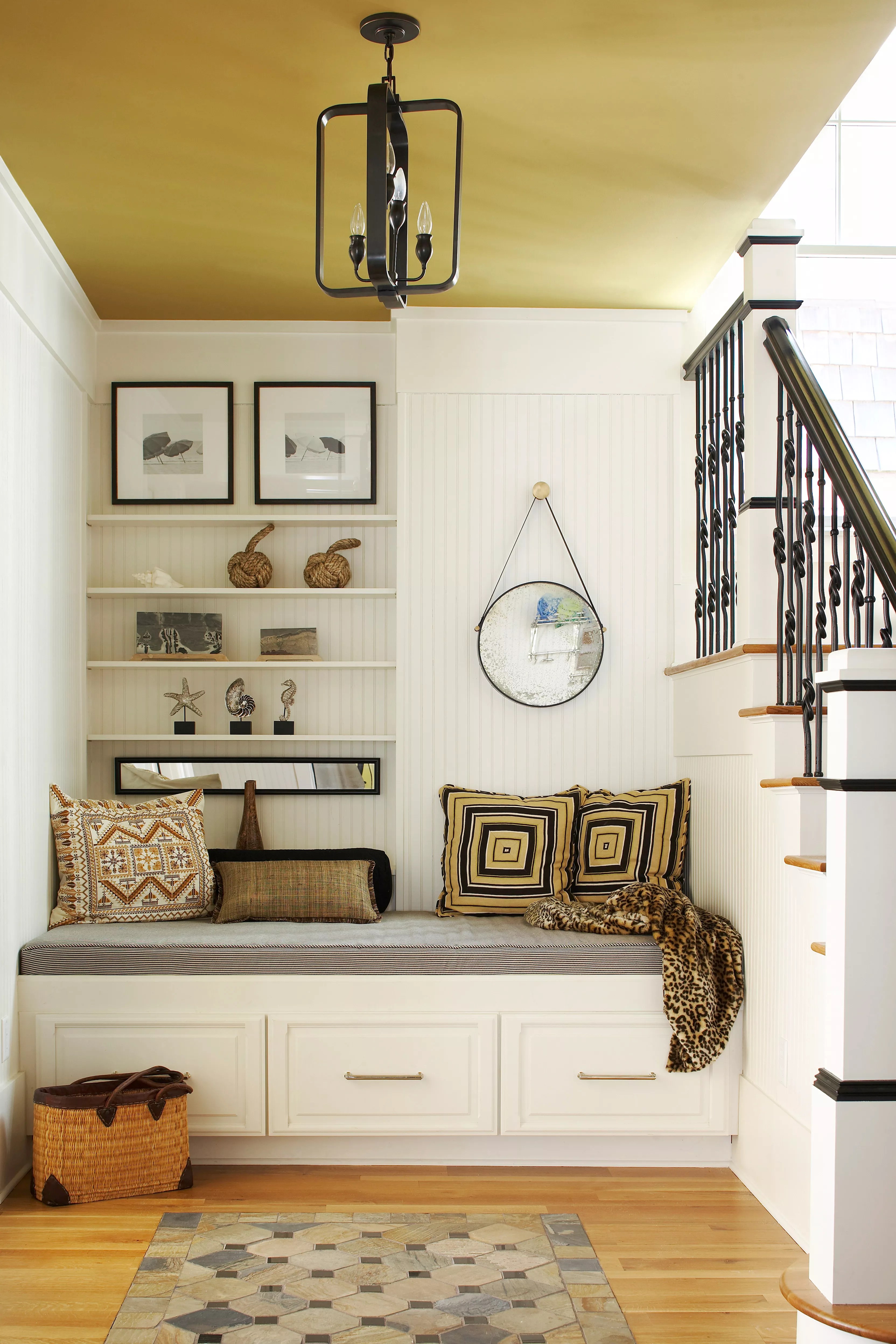 Built-in bench with pillows, shelves, and a mirror