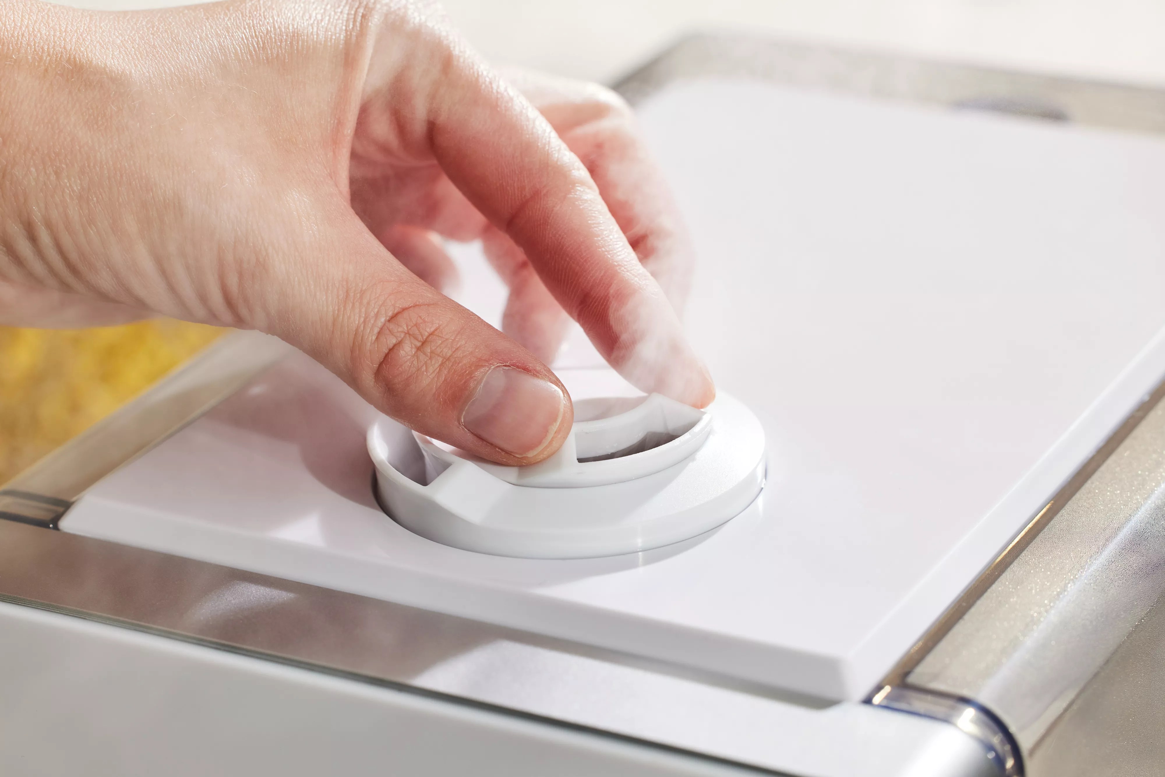 A person adjusting the Levoit LV600S Smart Warm and Cool Mist Humidifier