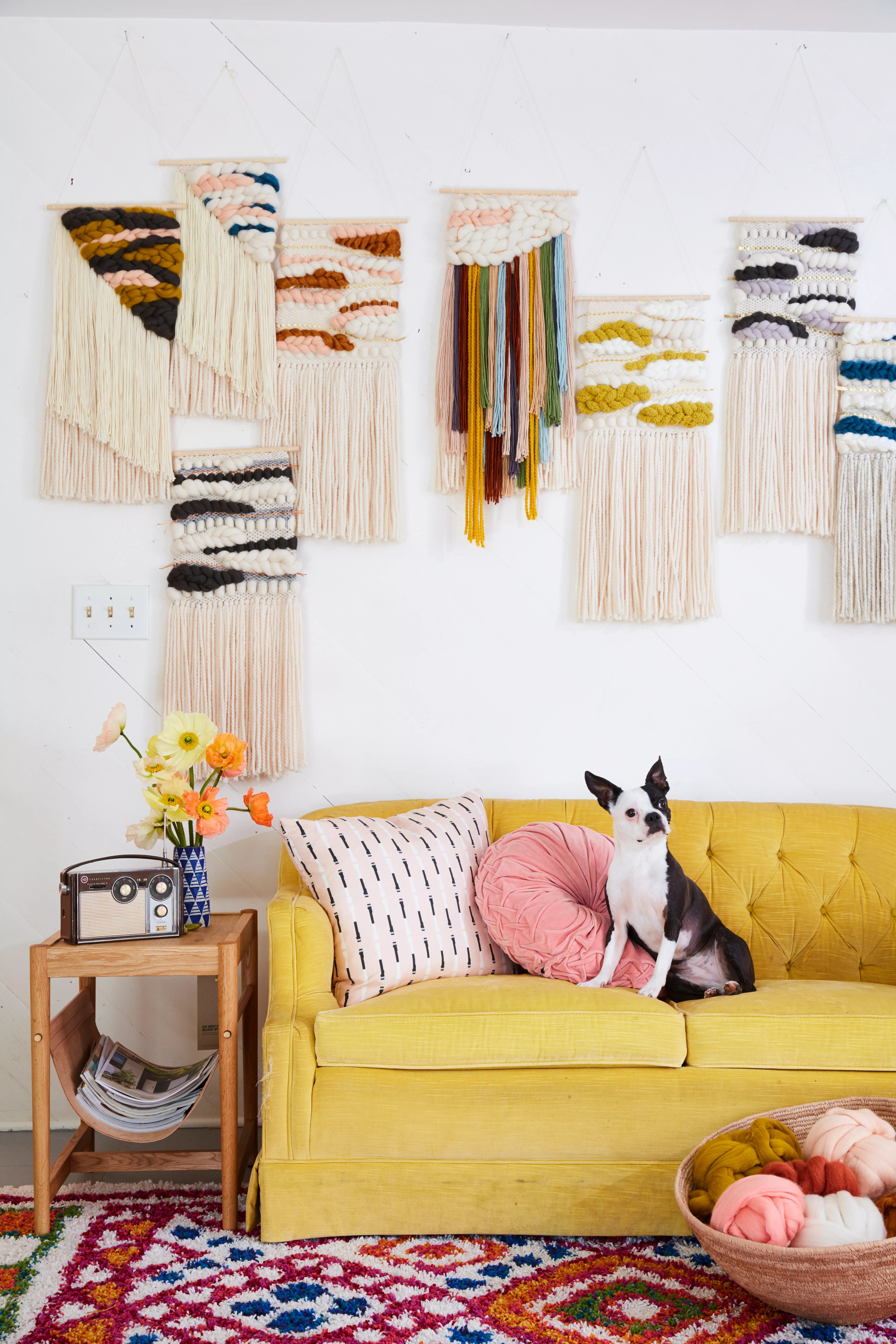 Living room with yellow couch and woven art hangings