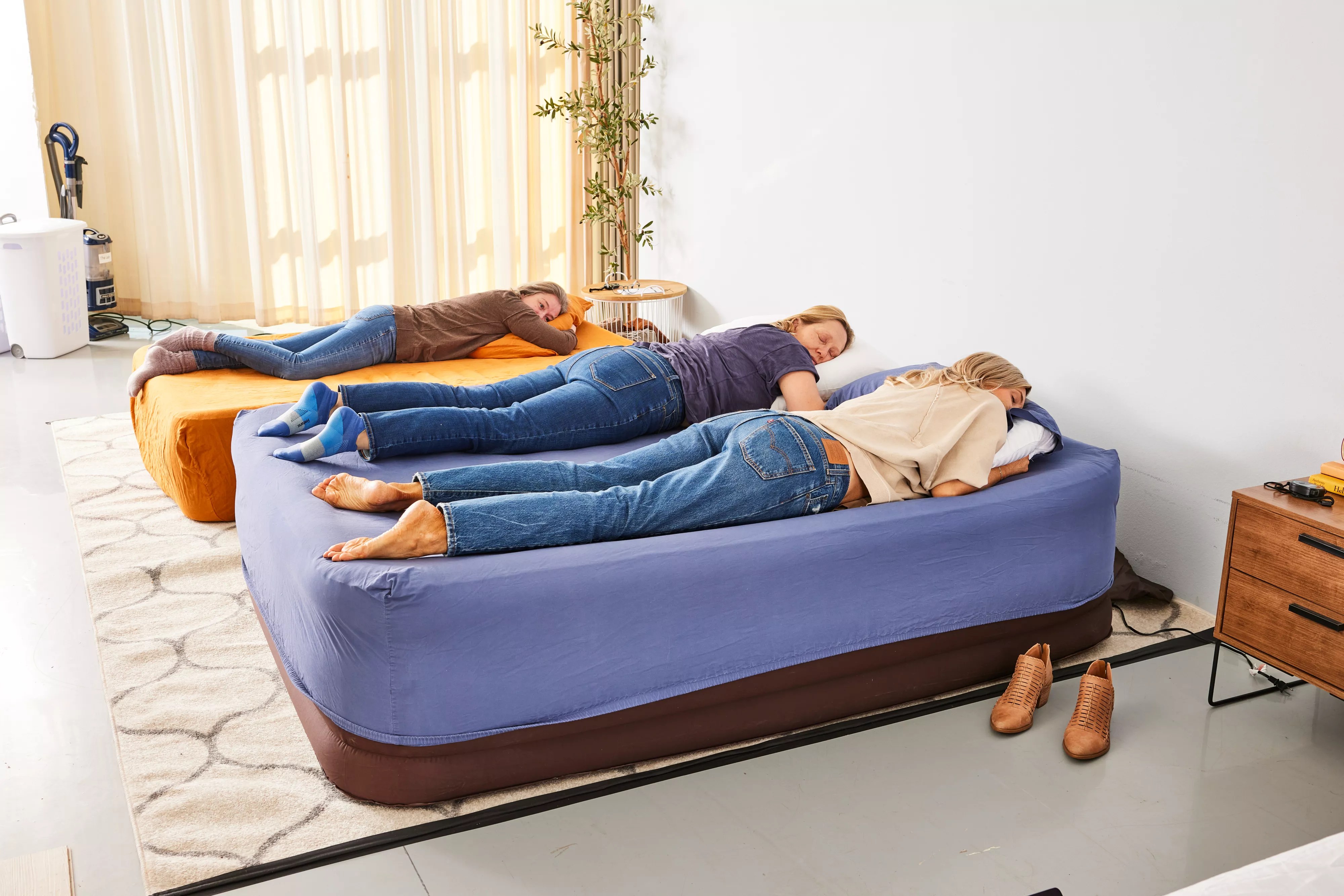 Two people sleep on the Englander Air Mattress