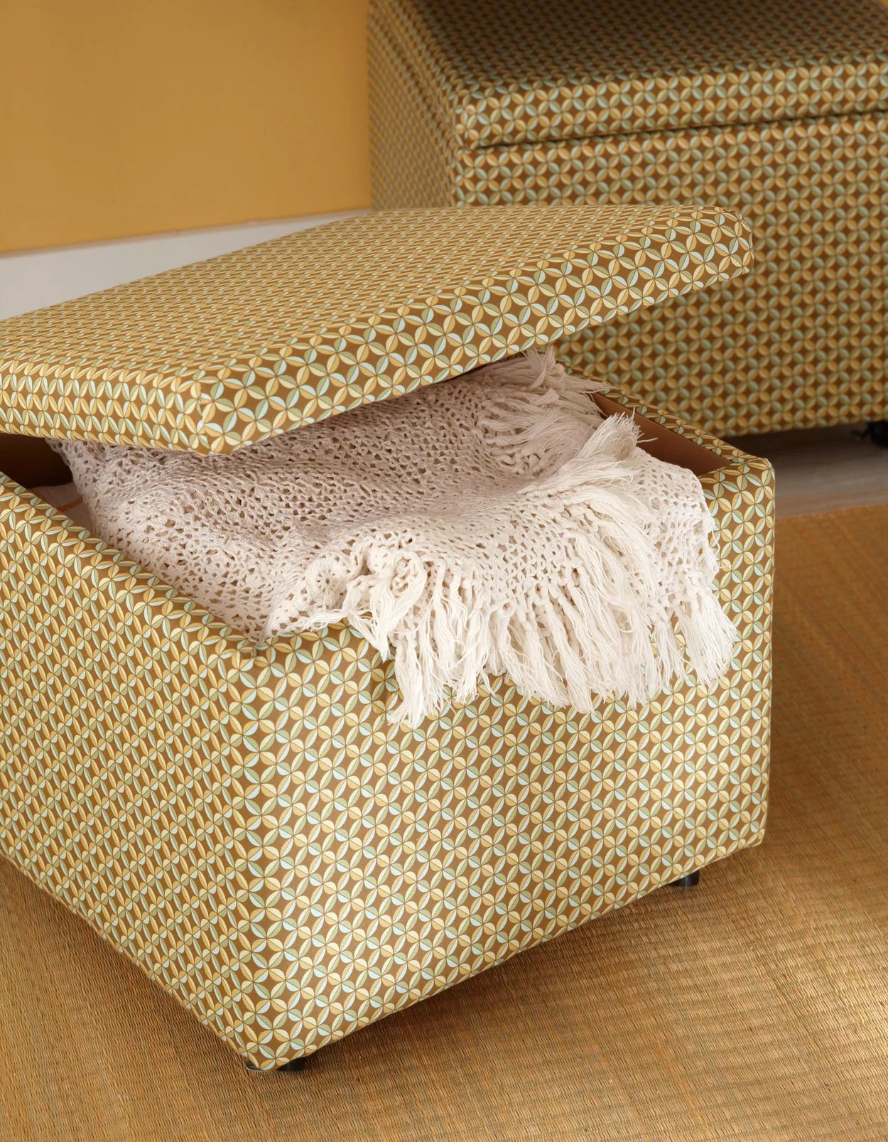 patterned fabric storage box with white blanket