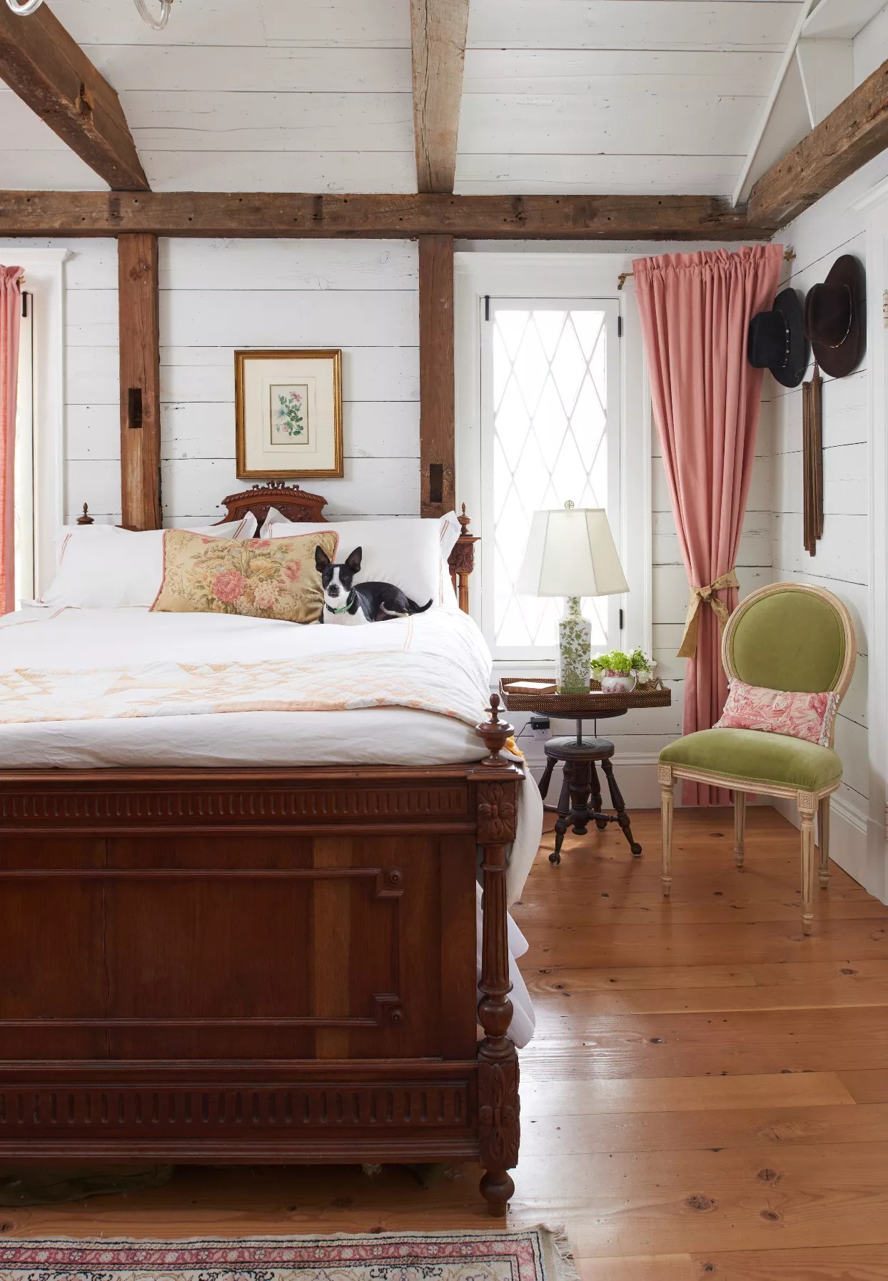 dog relaxing on white bed in farmhouse