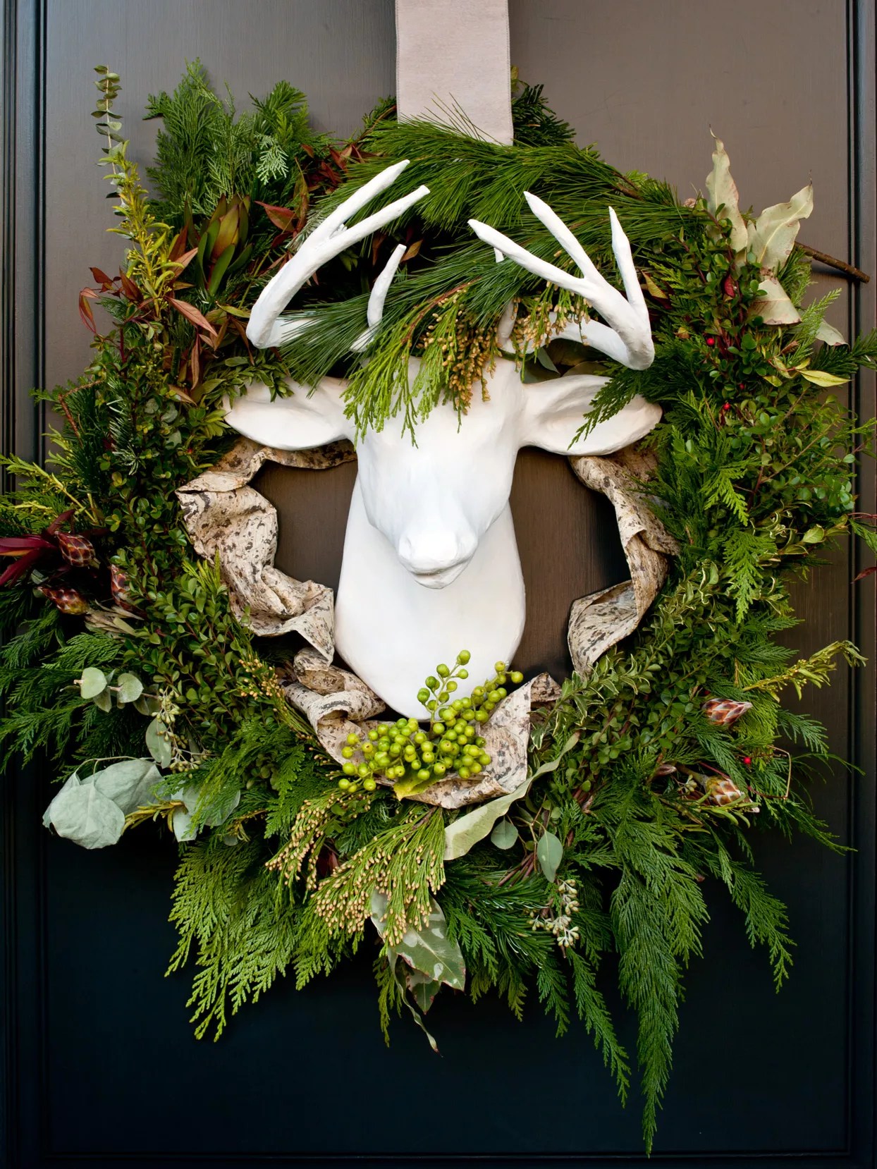 wreath around white ceramic reindeer head