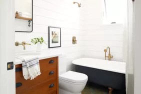 white bathroom with shiplap walls and clawfoot tub
