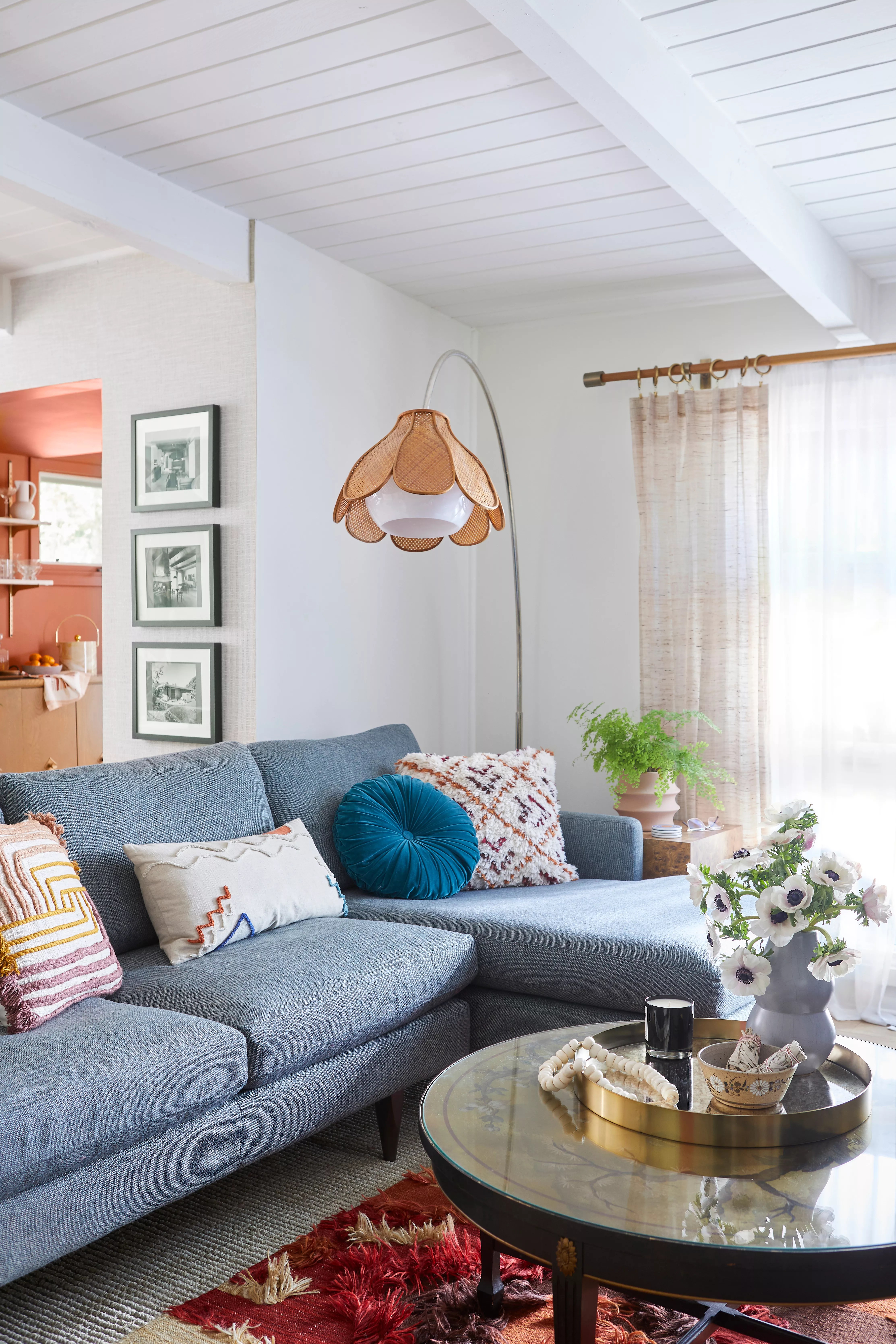 Blue couch with a tulip floor lamp