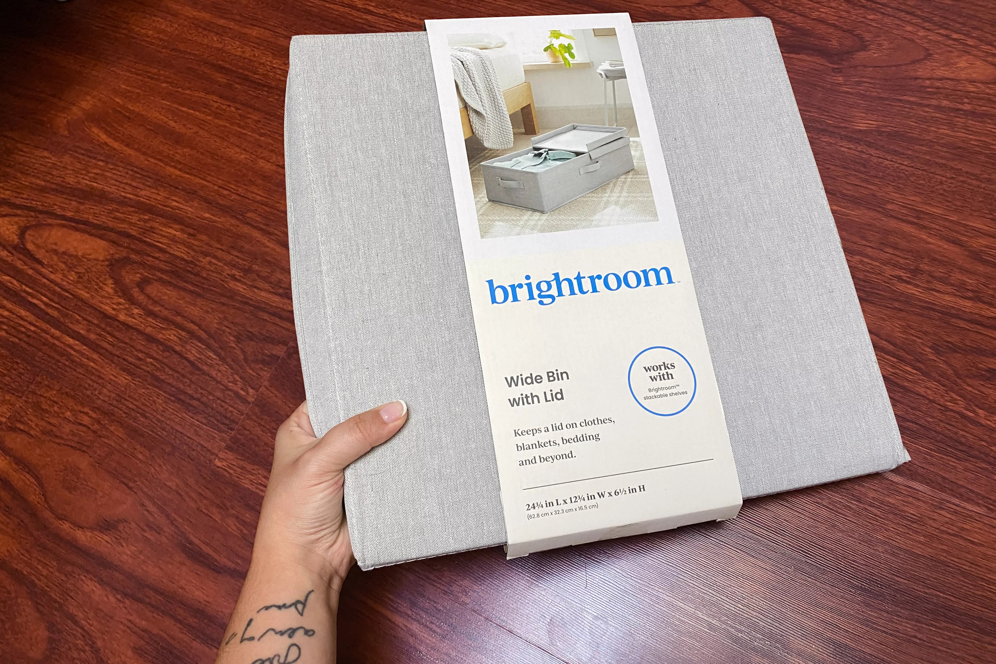A person holding the Brightroom Underbed Fabric Bin that has a lid