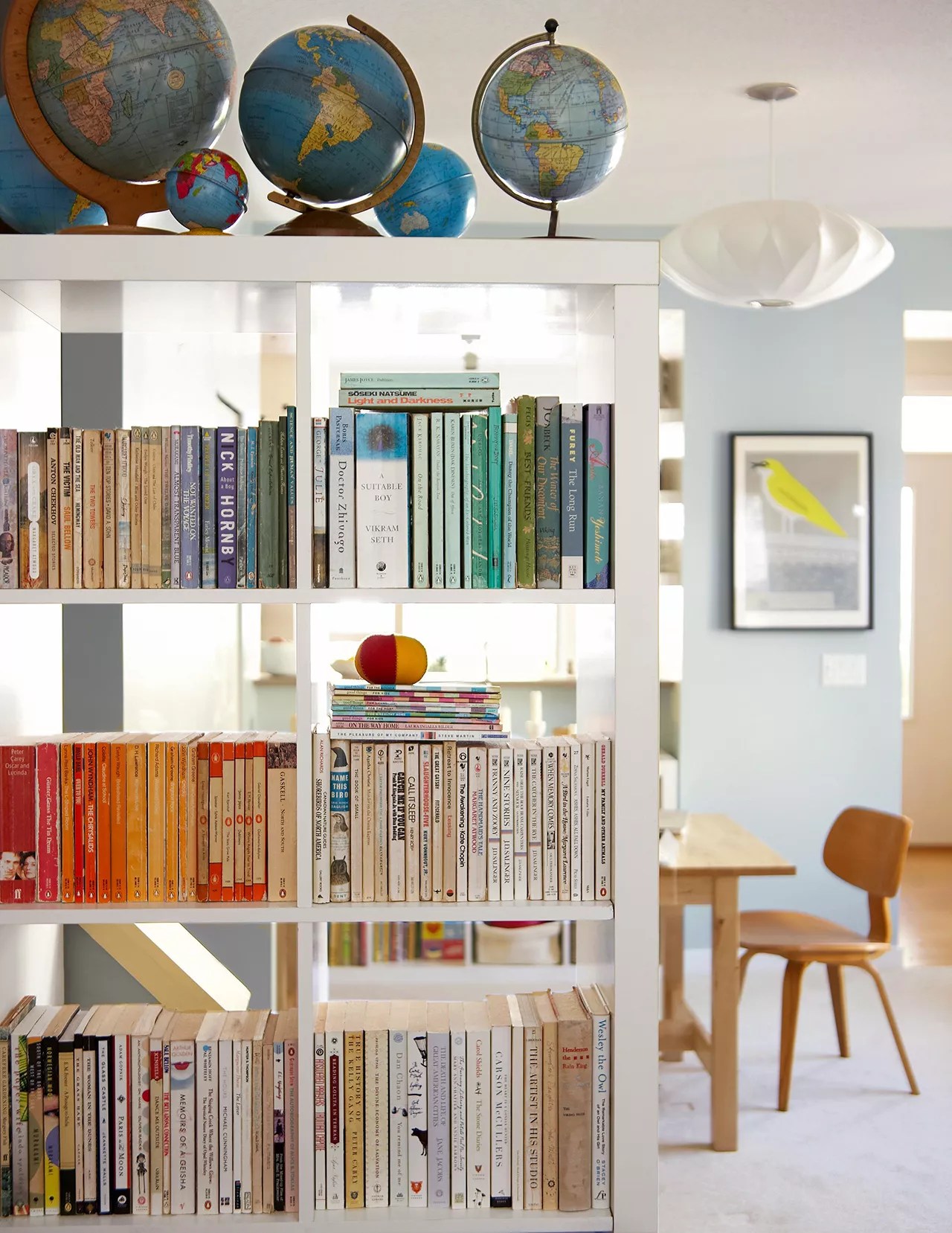 home bookshelf with globes above