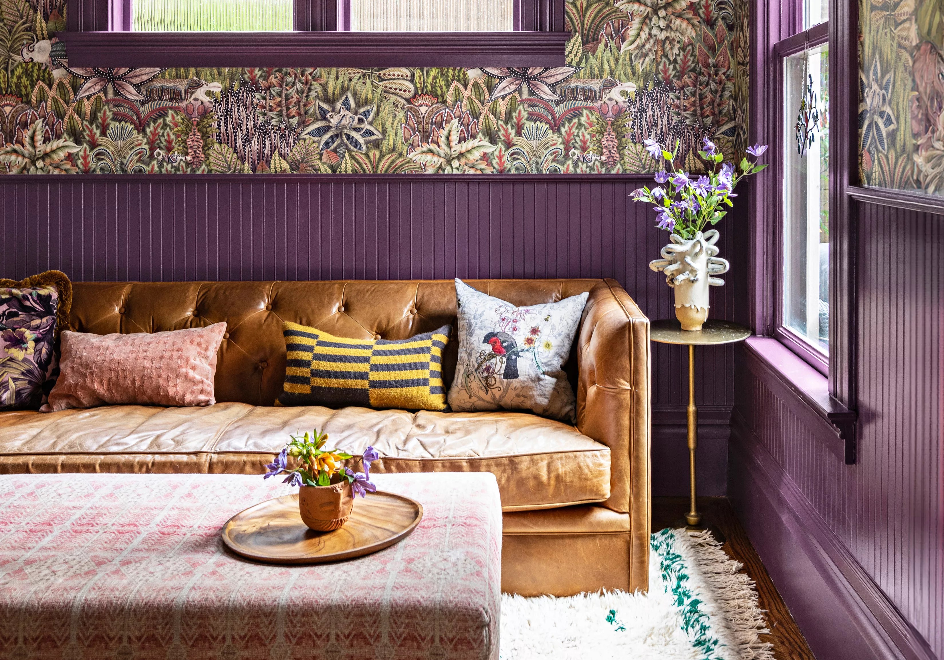 purple wall and light brown couch