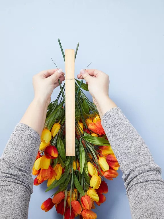 tying tulips to wooden board