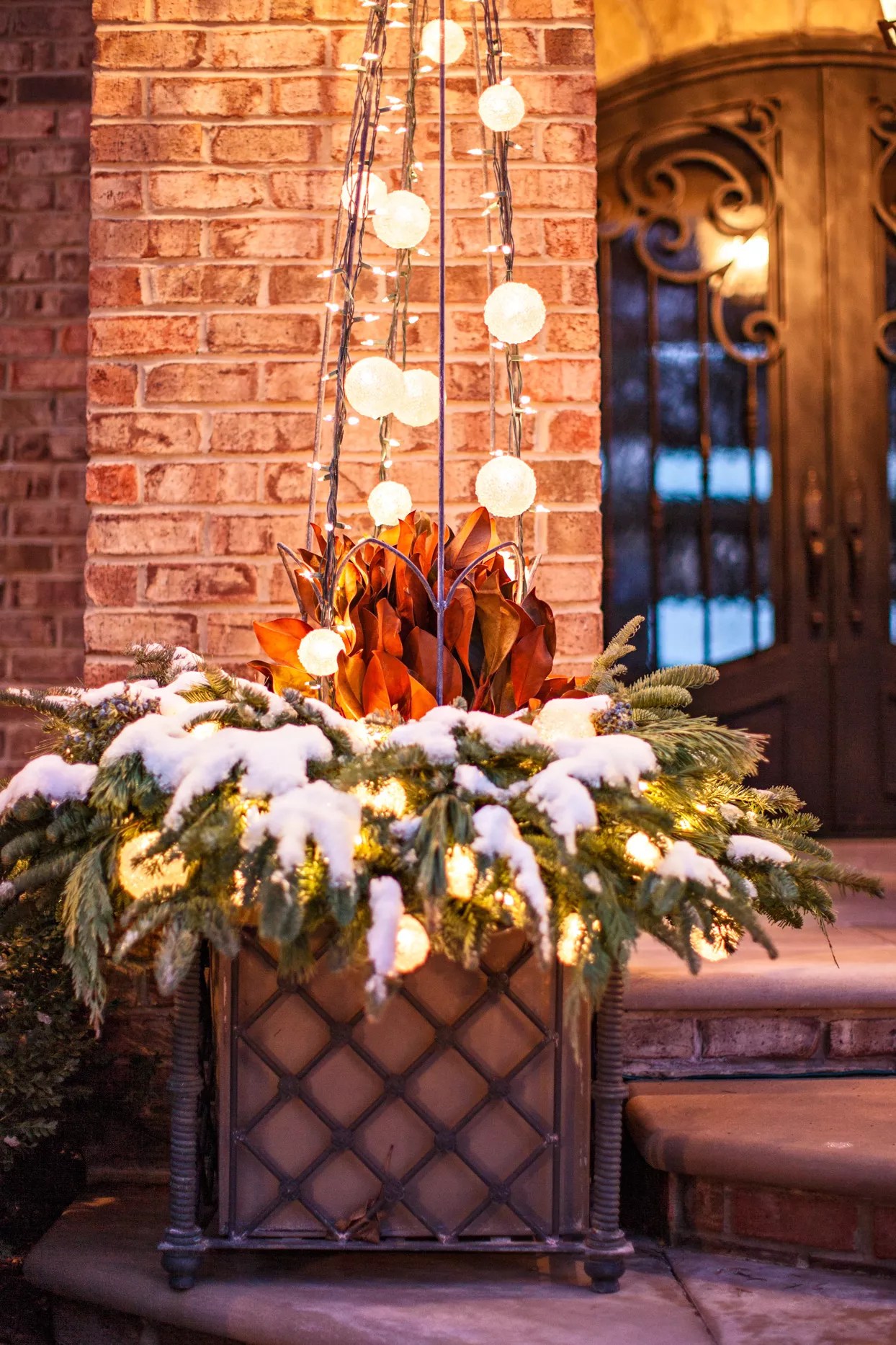 planter decorated with glowing snow globes