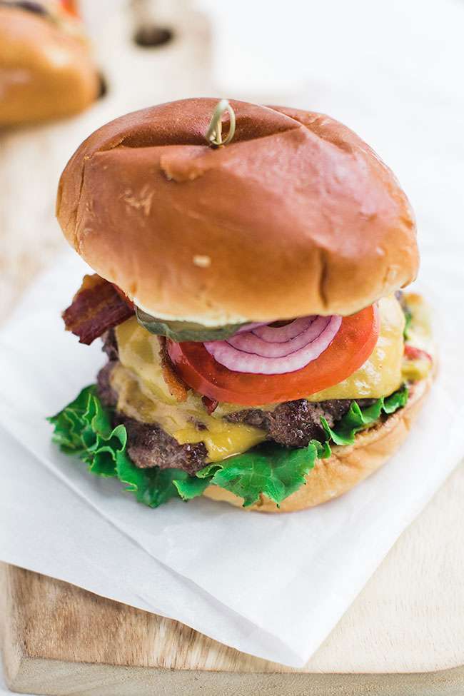 Classic Cheeseburger Recipe on Brioche with Lettuce Tomato and Onions