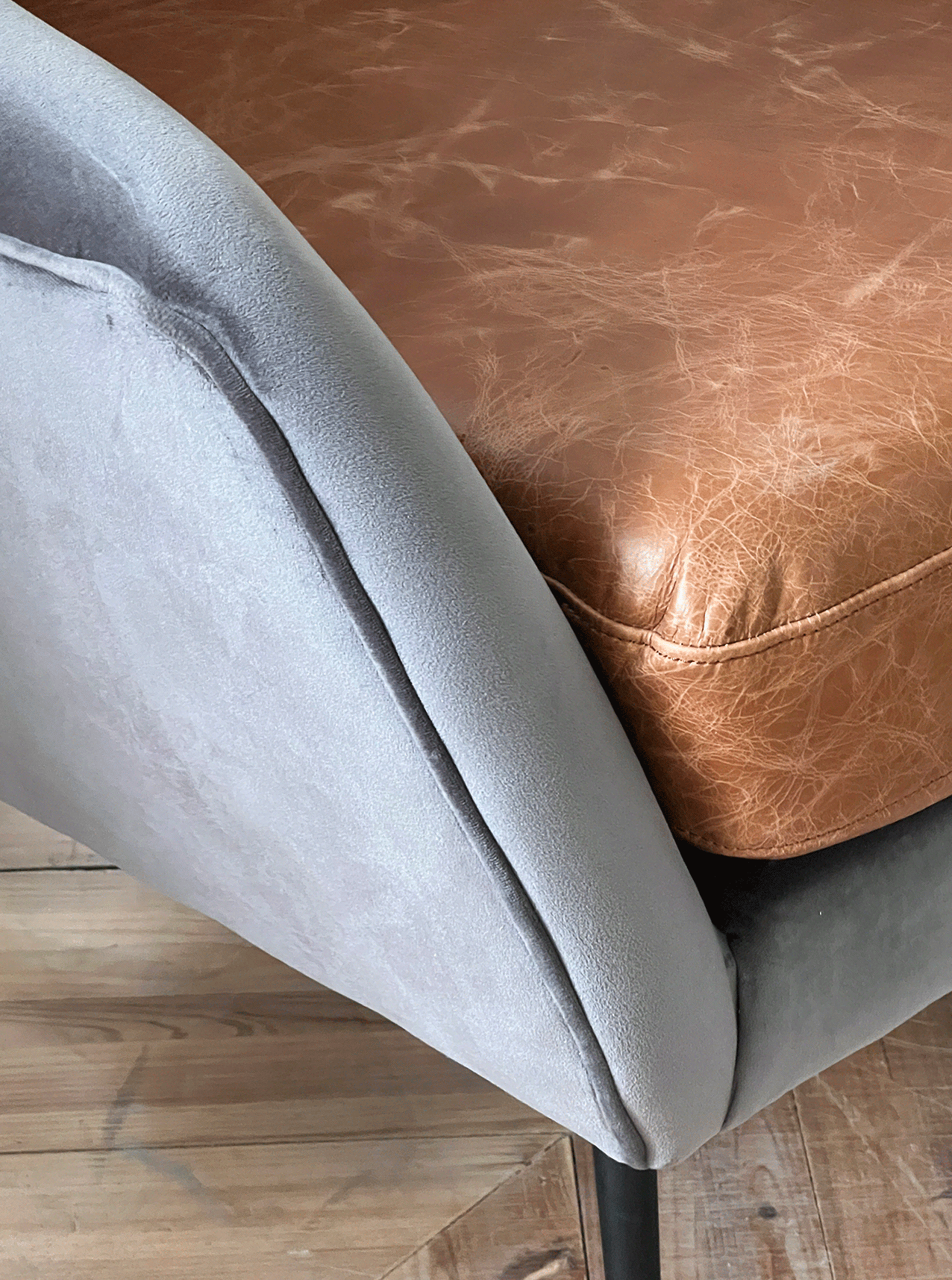 Blue velvet sofa with handwoven rugs and round metal coffee table