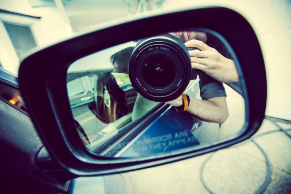 photo of camera looking at car side mirror
