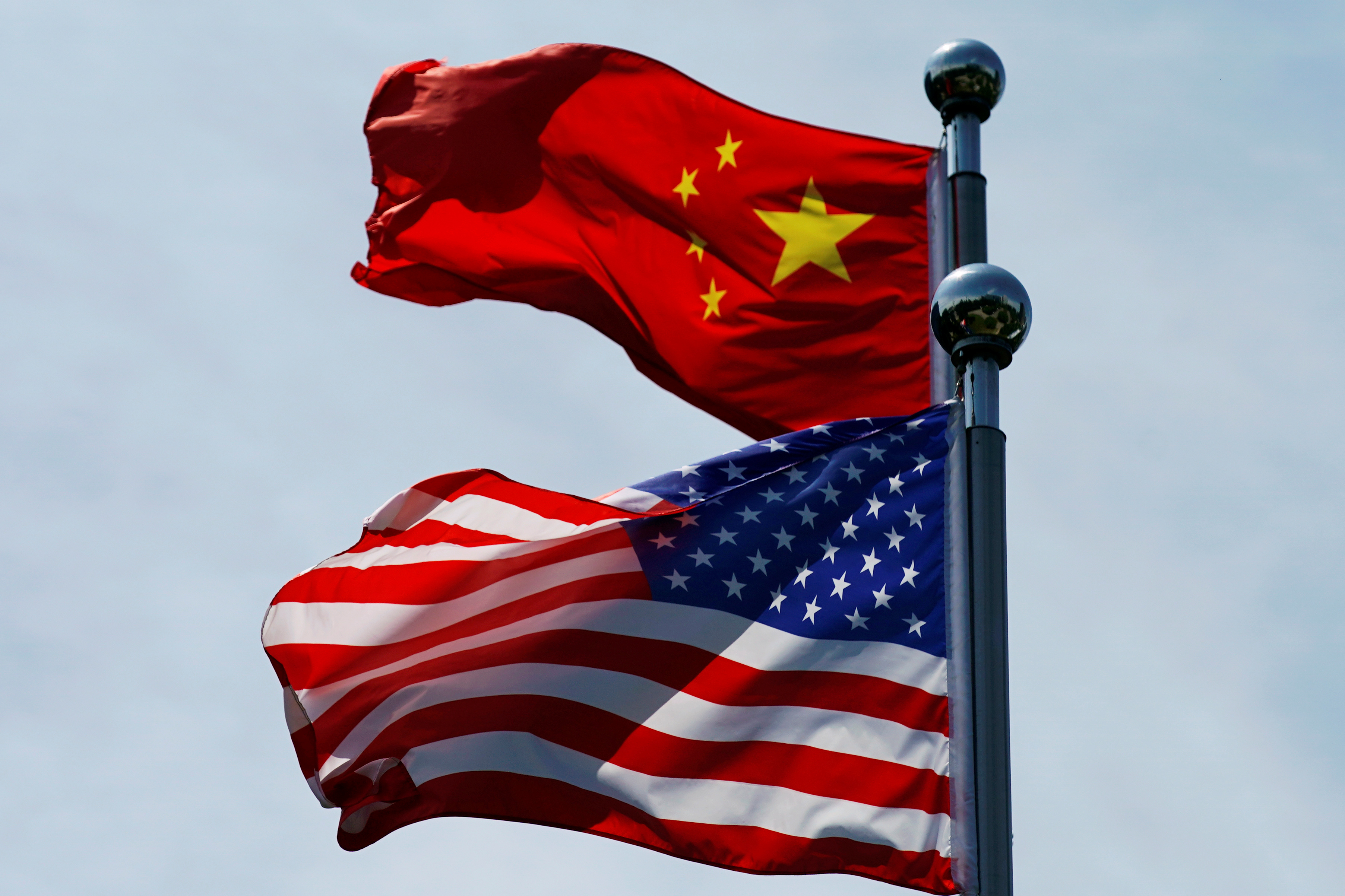 Chinese and U.S. flags flutter near The Bund, before U.S. trade delegation meet their Chinese counterparts for talks in Shanghai, China July 30, 2019. REUTERS/Aly Song - RC187164FDE0