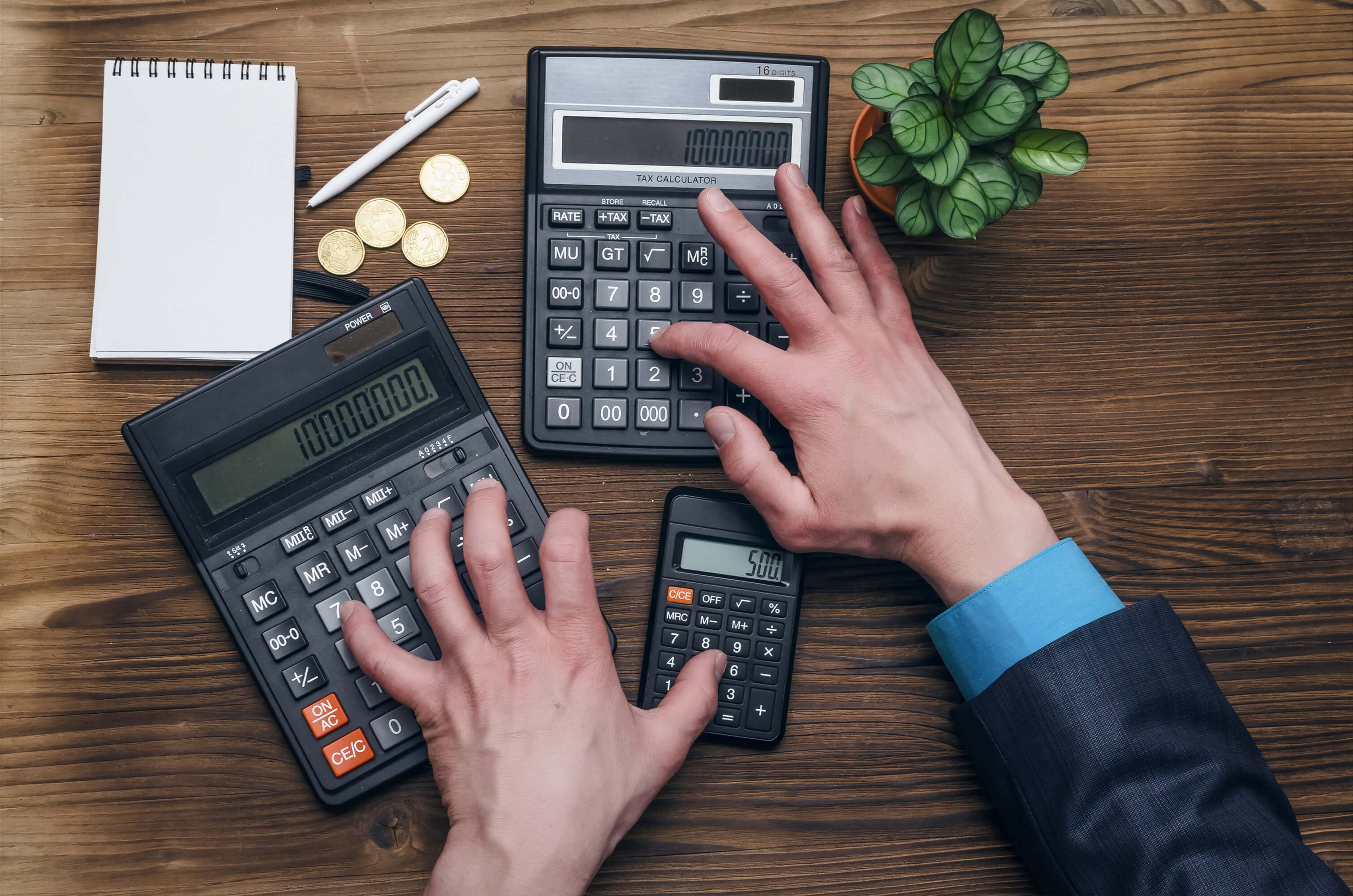 Business man calculating money or taxes with calculator. Profit