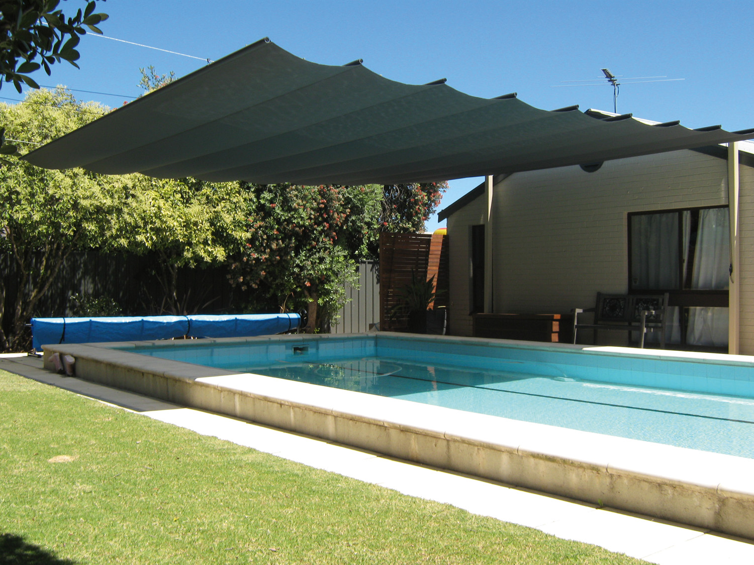 Cool your outdoor entertaining area with a retractable shade system