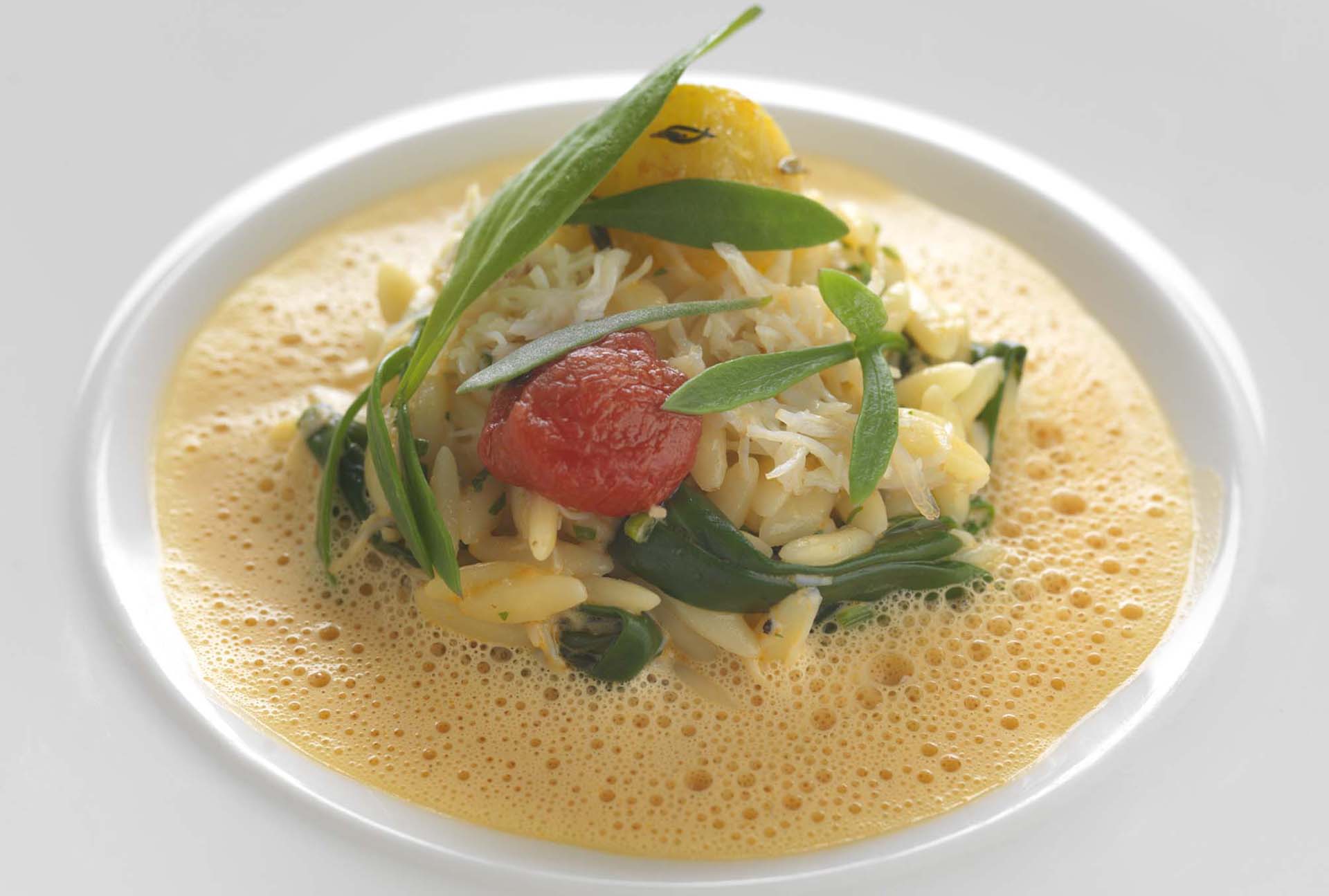 Recipe Crab and orzo pasta, crab sauce, confit tomato and sea vegetables